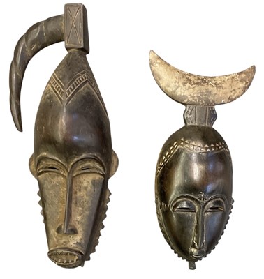 Lot 1034 - Two African carved wooden tribal masks, both...