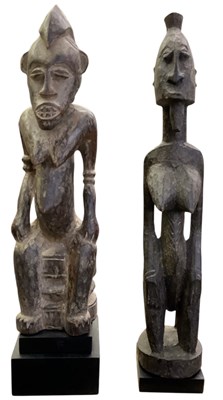 Lot 1033 - Two African carved wooden tribal figures,...