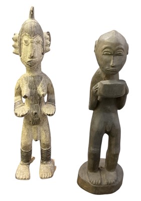 Lot 1021 - Two African carved wooden tribal figures...