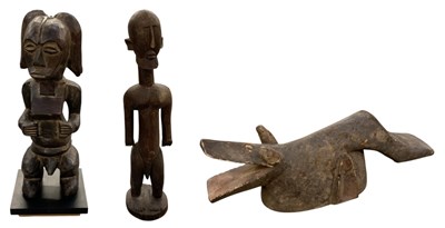 Lot 597 - An African carved wooden tribal figure of a...