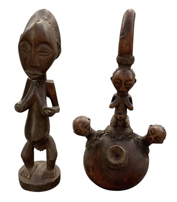 Lot 1027 - A small African carved wooden tribal figure,...