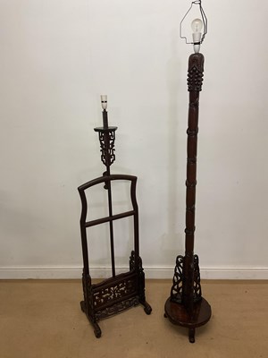 Lot 21 - Two Chinese hardwood standard lamps, one with...
