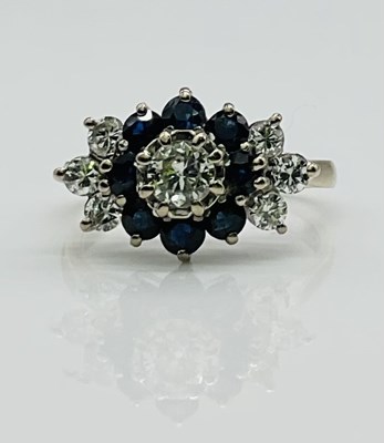 Lot 563 - An 18ct white gold diamond and sapphire...