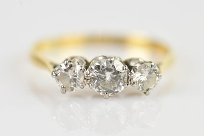 Lot 2431 - An 18ct yellow gold and platinum set three...