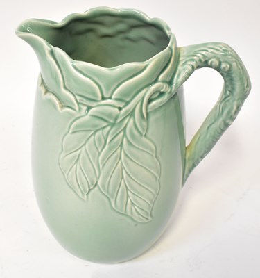 Lot 141 - CLARICE CLIFF; a moulded green porcelain jug...