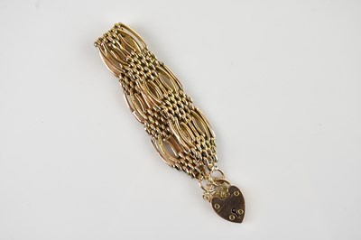 Lot 1114 - A yellow metal gate link bracelet, stamped '9c'...