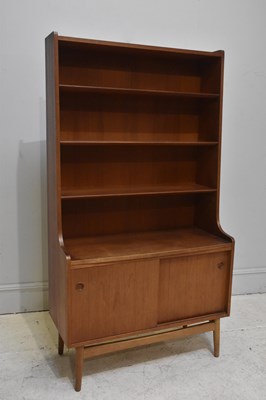 Lot 19 - A mid century teak bookcase with three shelves...