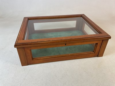 Lot 807 - A glass table top satin walnut cabinet with...