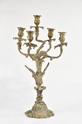 Lot 421 - An ornate brass candelabra, decorated with...