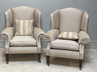 Lot 45 - DURESTA; a pair of cream upholstered wingback...