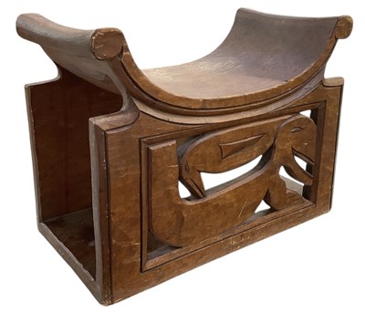Lot 1023 - An African carved hardwood saddle seated stool,...