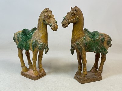 Lot 8 - A pair of Chinese Tang figures of caparisoned...