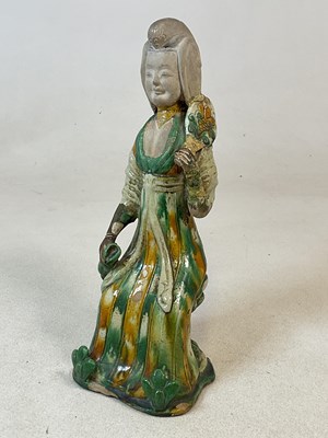 Lot 15 - A Tang Sancai glazed figure of a seated female,...