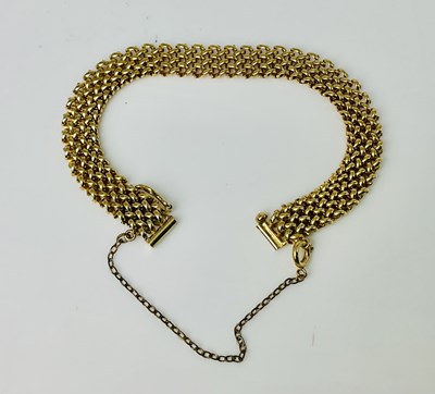Lot 596 - A 9ct yellow gold flat link bracelet, with...