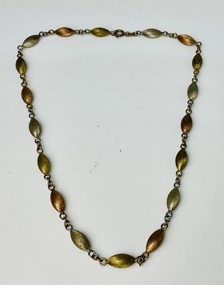 Lot 599 - A 9ct three tone textured bead necklace,...