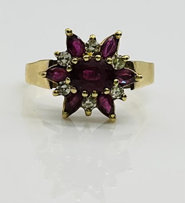 Lot 613 - An 18ct yellow gold diamond and ruby floral...