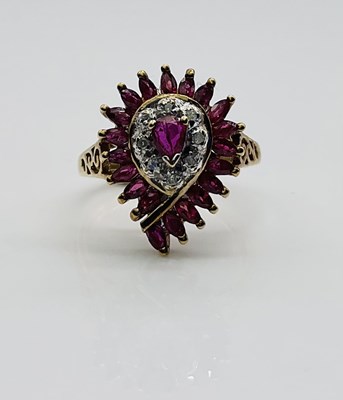 Lot 627 - A 9ct yellow gold ruby set pear shaped dress...