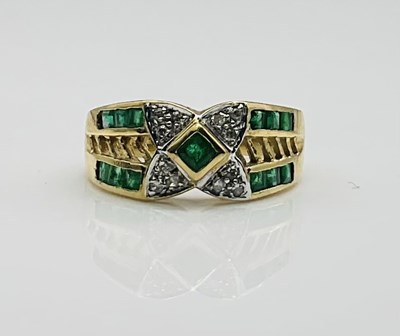 Lot 630 - A 9ct yellow gold emerald and diamond ring,...