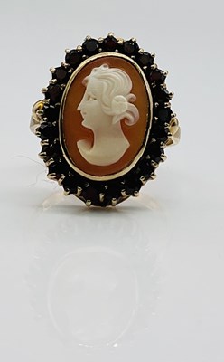 Lot 636 - A 9ct yellow gold garnet and cameo dress ring,...