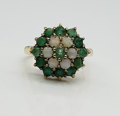Lot 641 - A 9ct yellow gold emerald and opal flower head...