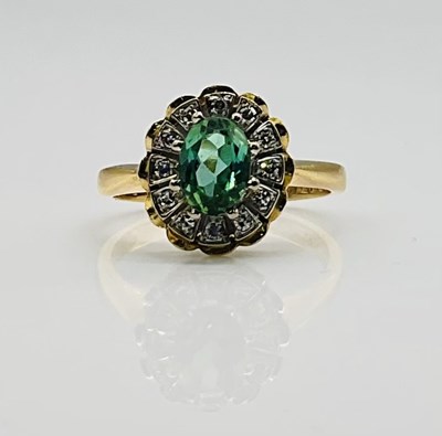 Lot 646 - An 18ct yellow gold oval green garnet and...