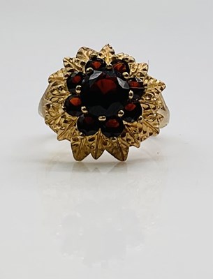 Lot 653 - A 9ct yellow gold domed and textured garnet...
