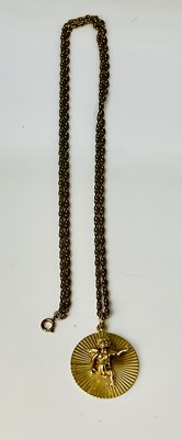 Lot 655 - A 9ct yellow gold circular pendant set with an...