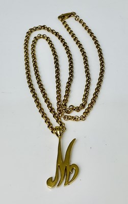 Lot 664 - A 9ct yellow gold hoop link chain supporting a...
