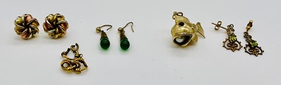 Lot 666 - A 9ct yellow gold fish charm with pearl in its...