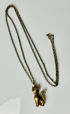 Lot 668 - A 9ct yellow gold cat pendant, suspended on...