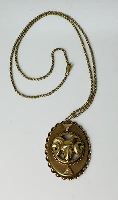 Lot 677 - A 9ct yellow gold ram oval pendant, length...