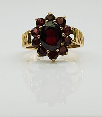 Lot 696 - A 9ct yellow gold garnet set floral cluster...