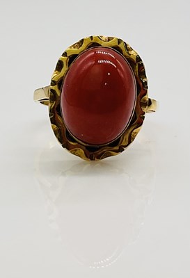 Lot 697 - A yellow metal cabochon set dress ring, size m,...
