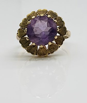 Lot 702 - A 9ct yellow gold amethyst dress ring, size o,...