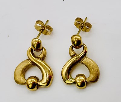 Lot 711 - A pair of 18ct gold earrings, combined approx...