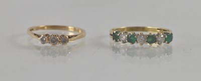 Lot 1246 - A 9ct yellow gold ring set with three white...