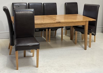 Lot 114 - A reproduction oak extending dining table,...
