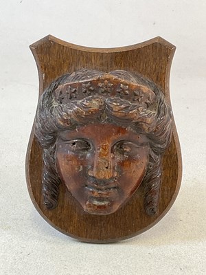 Lot 172 - An early carved wooden plaque of a woman...
