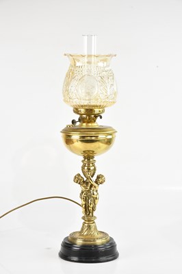 Lot 2041 - A brass converted oil lamp, decorated with...