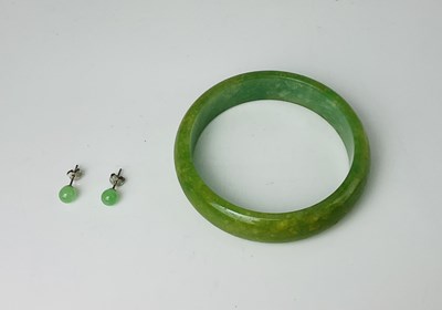 Lot 675 - A jade bangle, internal width 57mm, together...