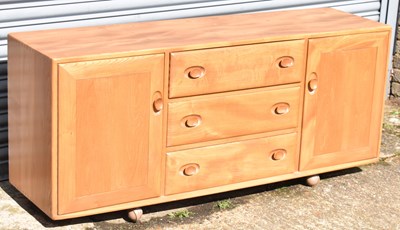 Lot 72 - ERCOL; a mid century light oak sideboard with...