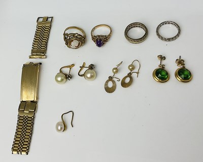 Lot 715 - A 9ct yellow gold eternity ring, a 9ct yellow...