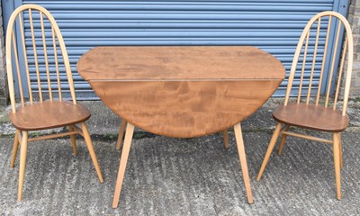 Lot 74 - ERCOL; a mid century light oak drop-leaf...