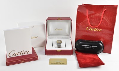 Lot 1387 - CARTIER; a unisex Santos model 1566 in bimetal...