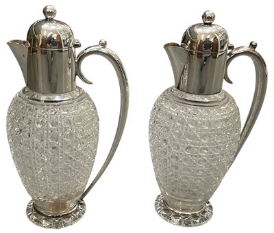 Lot 1094 - A pair of cut glass claret jugs with silver...