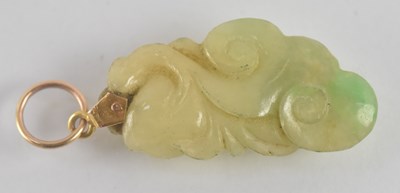 Lot 1275 - A Chinese carved jade pendant, with yellow...