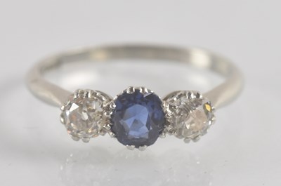 Lot 1301 - A platinum sapphire and diamond three stone...