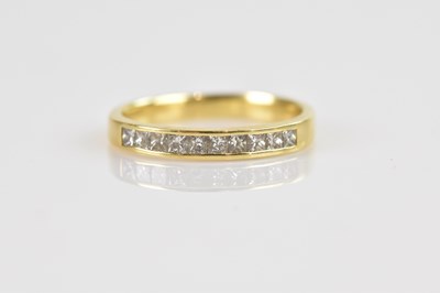 Lot 2429 - An 18ct yellow gold diamond set half eternity...
