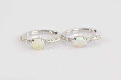 Lot 1386 - A pair of 18ct white gold diamond and opal set...
