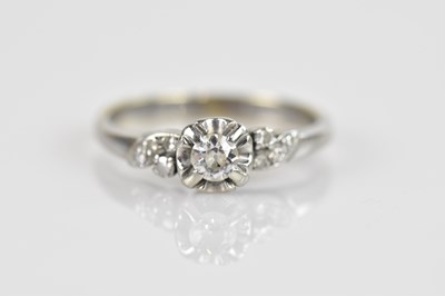 Lot 2394 - A white metal diamond illusion set dress ring,...